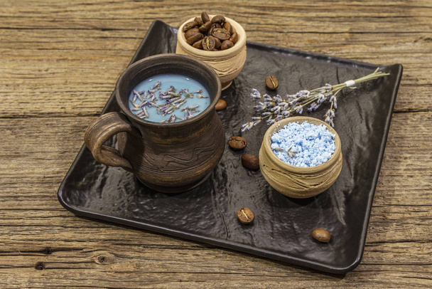 Trendy colored latte. Lavender and powdered aromatic sugar, coffee beans. Wooden boards background - Foto, Imagen
