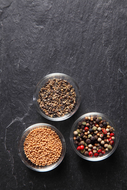 Close up Assorted Seed Type Spices on Containers Placed on slate background, Emphasizing Copy Space. - Photo, Image