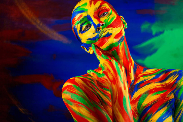 Color art face and body paint of woman for inspiration. Abstract portrait of the bright beautiful girl with colorful make-up and bodyart. - Фото, изображение