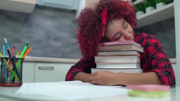 Exhausted student girl sleeping on pile of books, overworked at school classes - Materiał filmowy, wideo