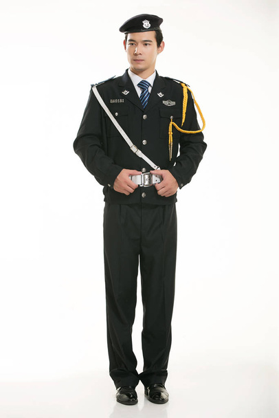 Create all kinds of work clothes policeman stands in front of a white background - Foto, immagini