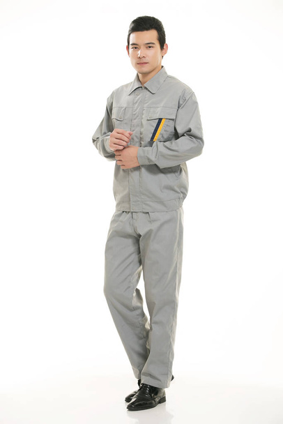 The young engineer various occupation clothing standing in front of a white background - Foto, Imagem