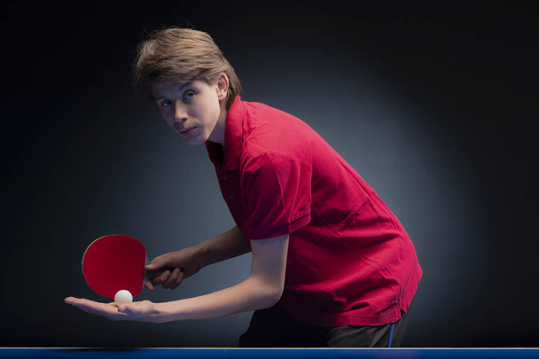 Portrait of young boy playing tennis  - Valokuva, kuva