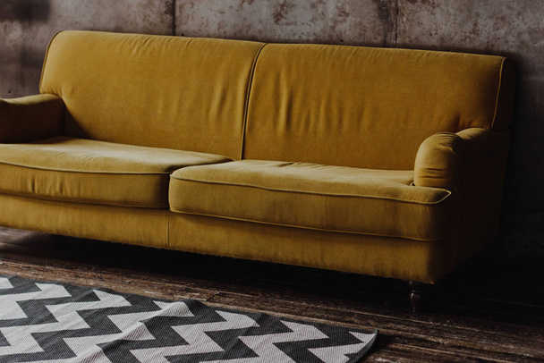 Yellow velvet couch in loft room - Fotoğraf, Görsel