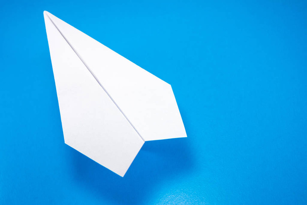 paper airplane made of white paper on a light blue background, copy space, mock up - Fotografie, Obrázek