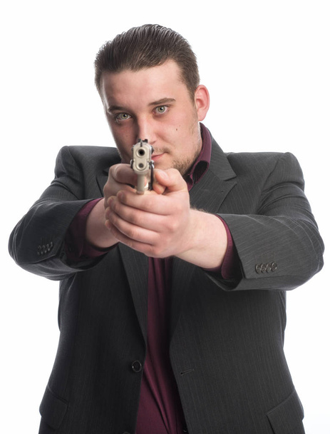 young man is aiming with gun - Foto, Bild