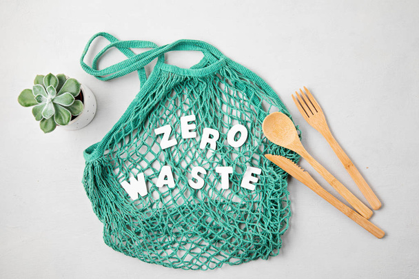 Zero waste concept. Set of eco friendly bamboo cutlery, mesh cotton bag, reusable coffee tumbler. Sustainable, ethical shopping, plastic free lifestyle. top view, flat lay.  - Zdjęcie, obraz