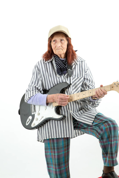 Funny elderly lady plays passionate electric guitar. - Zdjęcie, obraz