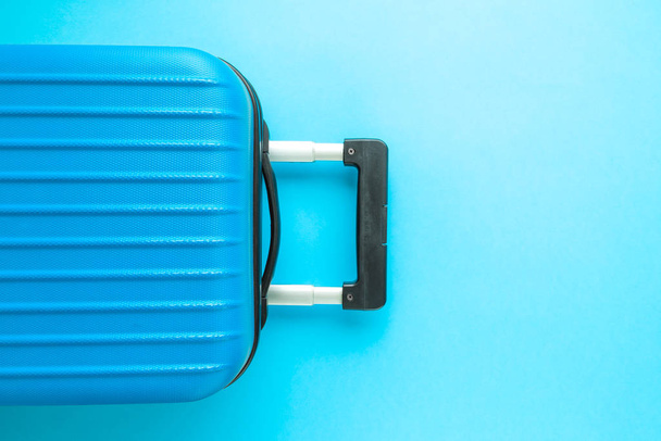 Flat lay of luggage on blue background vacation concept. - Foto, immagini