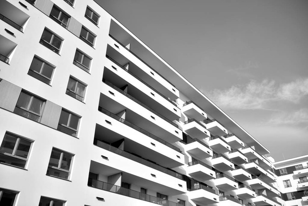 Modern and new apartment building. Multistoried, modern, new and stylish living block of flats. Black and white. - Fotoğraf, Görsel