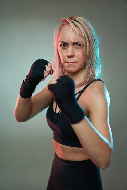 Woman fighter doing shadow boxking with hands wrapped - Valokuva, kuva