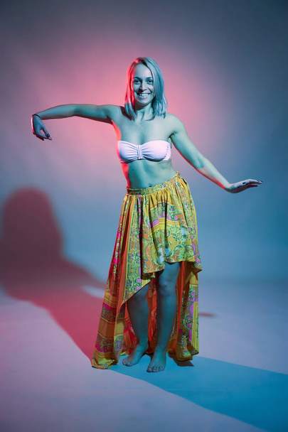 Beautiful blonde dancer in bellydance costume, studio shot - Foto, Imagen