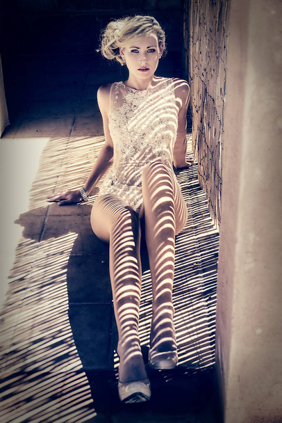 model lying in the shade of a blind - Foto, Imagen