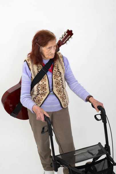 Elderly lady with rollator and musical instruments. - Фото, зображення