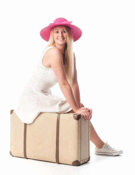 girl sitting on a suitcase and waiting - Foto, Imagen