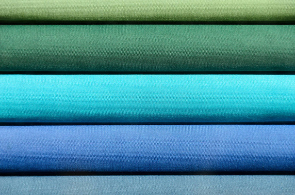Stack of Book spines covered with linen for background purpose, green and blue - Fotó, kép