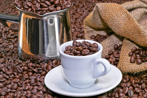 Small coffee cup with lot of Arabica beans - Фото, изображение