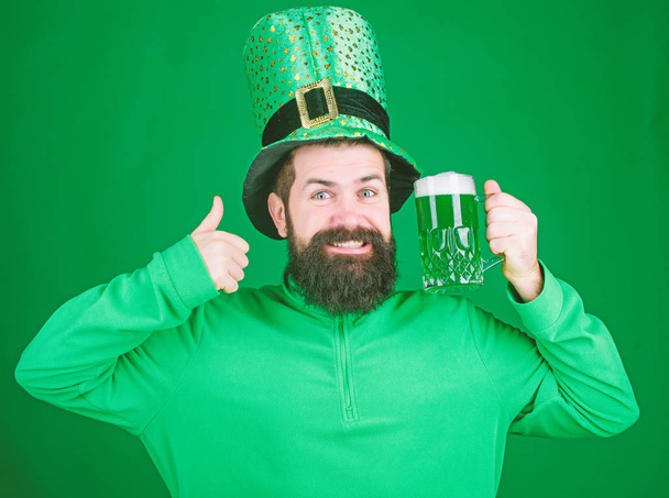 Fest and holiday menu. Dyed green traditional beer. Patricks day party. Alcohol beverage. Symbol of Ireland. Man bearded hipster drink beer. Irish pub. Drinking beer celebration. Highly recommend - Foto, Bild