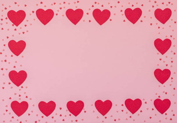 Valentine's Day pink background with red hearts. Valentine greeting card. Flat lay style with copy space.	 - Foto, afbeelding
