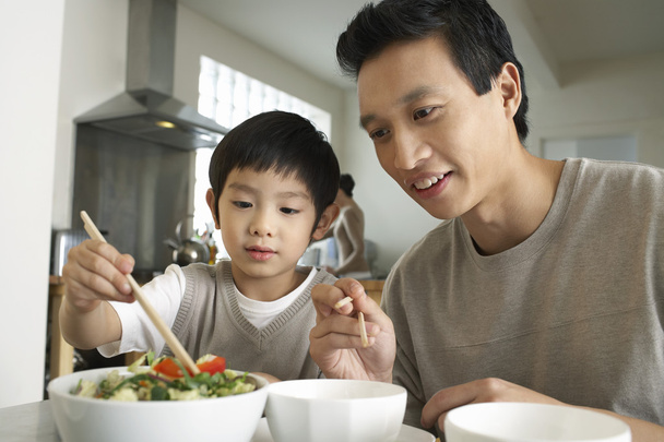 father and son using  chopsticks - Foto, Imagen