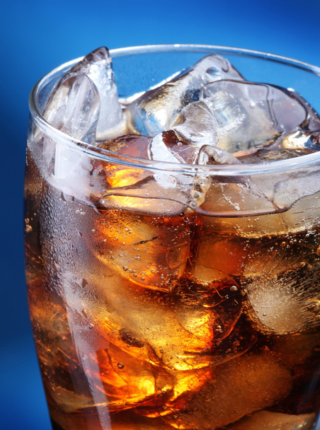 Glass of ice cola on a blue background - Photo, Image