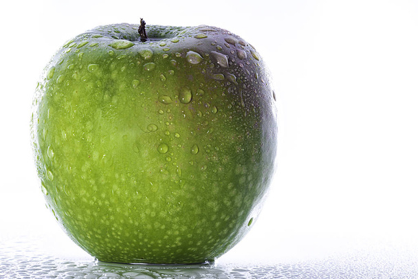 fresh green apple in front of white background - 写真・画像