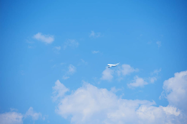 modern airplane travel,  clear blue sky in background - Foto, afbeelding