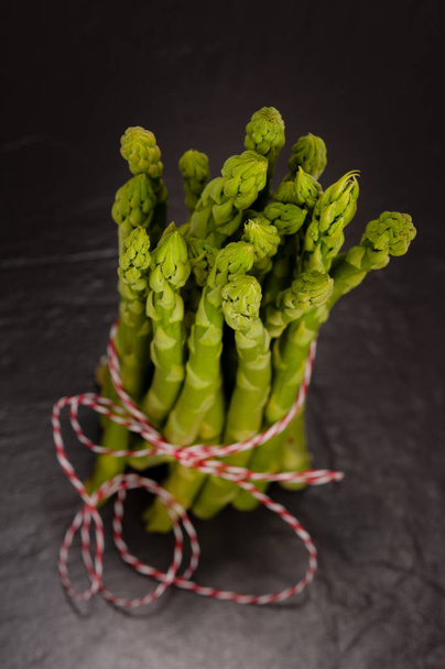 green asparagus on a slate plate. - Fotó, kép