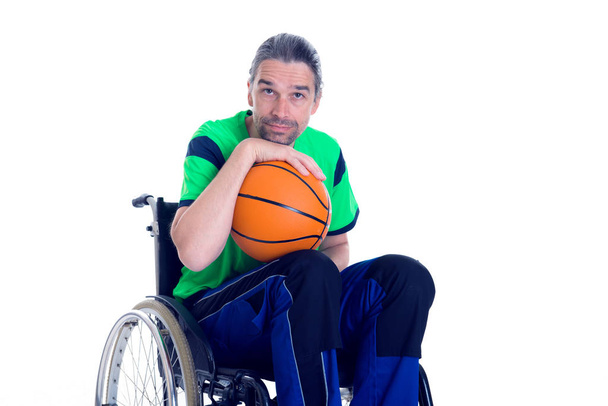young disabled man in a wheelchair is doing sport with ball - Foto, immagini
