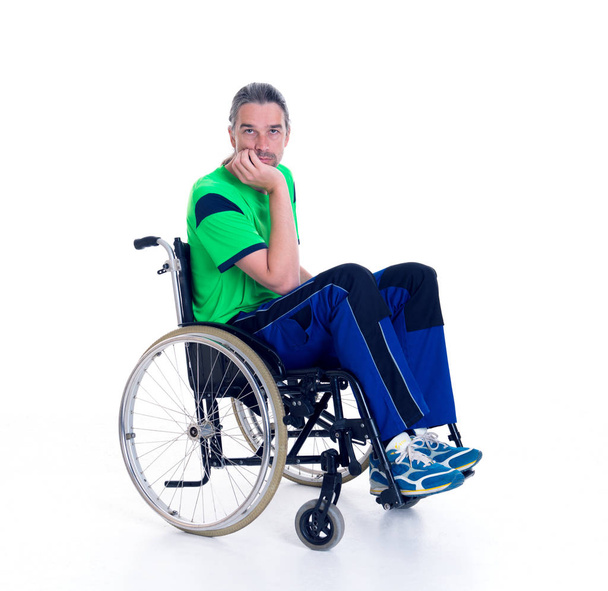 young man in a wheelchair in front of white background is sad - Photo, Image
