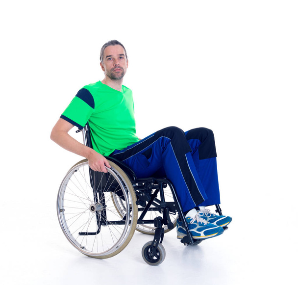 young man in a wheelchair in front of white background - Foto, afbeelding