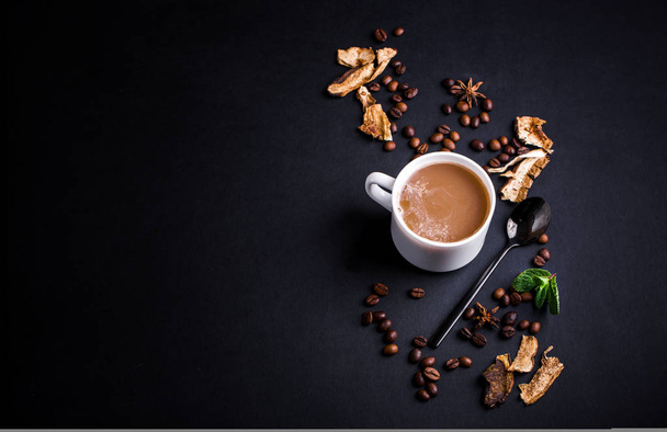 Mushroom Chaga Coffee Superfood Trend-dry and fresh mushrooms and coffee beans on dark background with mint. Coffee break - Photo, Image
