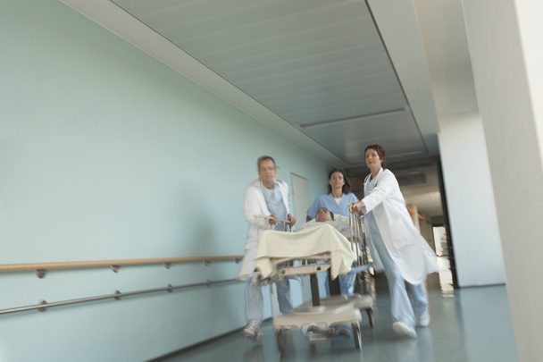 Physicians Rushing Patient on gurney - Foto, imagen