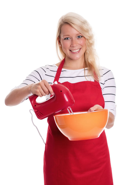 woman in apron stirred with a mixer in a bowl - Фото, зображення