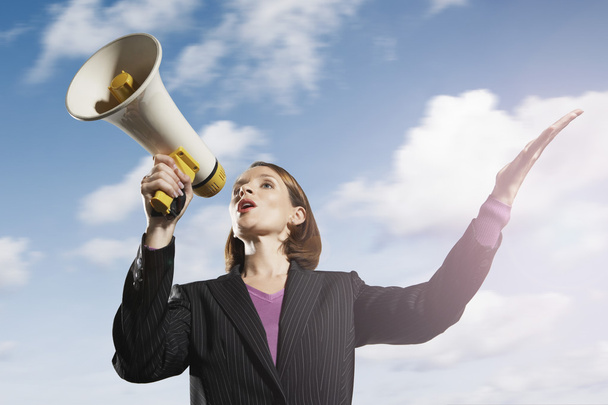 Businesswoman shouting through megaphone - Foto, afbeelding