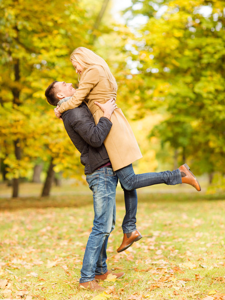 Romantic couple playing in the autumn park - Фото, зображення