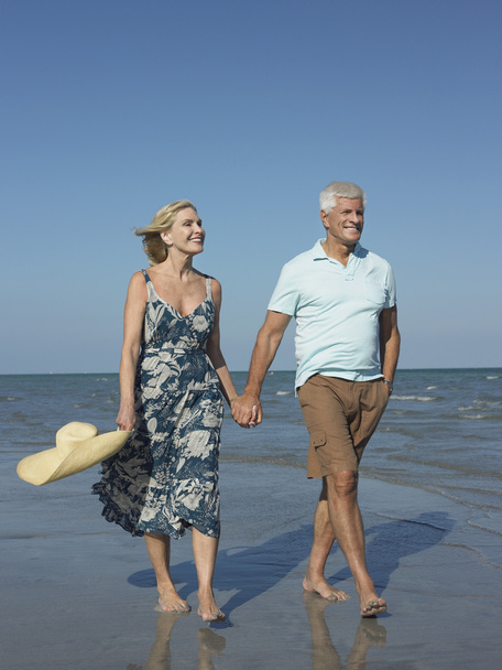 Senior couple walking on beach - Fotó, kép