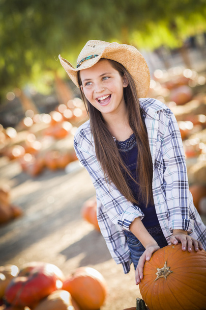 Preteen Girl Playing with a Wheelbarrow at the Pumpkin Patc - Photo, Image