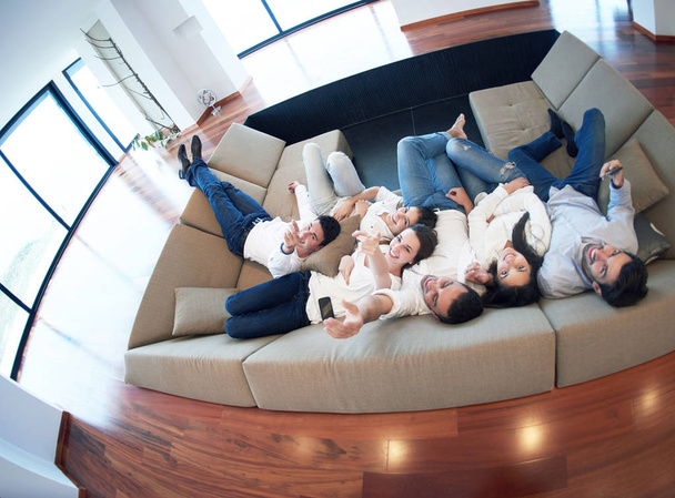 portrait of happy young group of friends get releax and have fun at modern home interior, top view - Photo, image