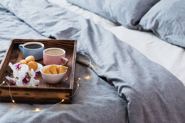 two cup of coffee on wooden tray in bedroom - Photo, Image