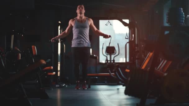 handsome male has workout with skipping rope in gym - Záběry, video