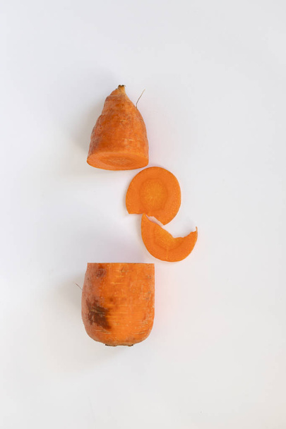 Ugly carrots on a white background. Ugly food concept, copy space. Sliced carrot isolated on white - Foto, Imagen