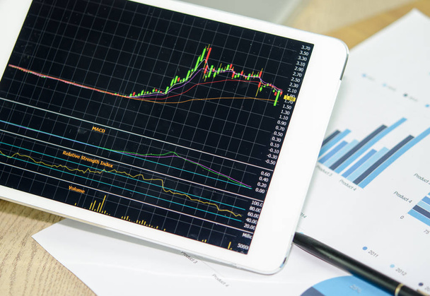 Analysing stock market with digital tablet. - Zdjęcie, obraz