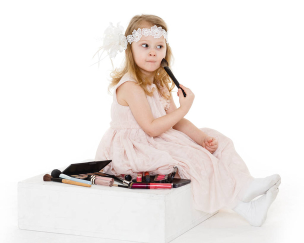 Pretty little girl playing with cosmetics on a white background. 3 year old. - Fotografie, Obrázek