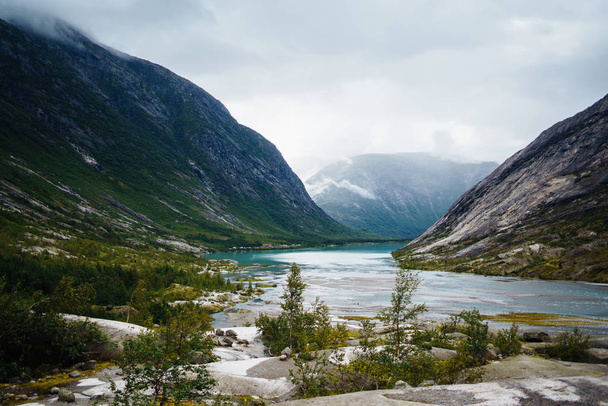 Picturesque landscape mountains of Norway. Beautiful view of the lake. Rocky shore of mountain lake in the morning. Travelling, lifestyle, wild nature concept. - Photo, Image