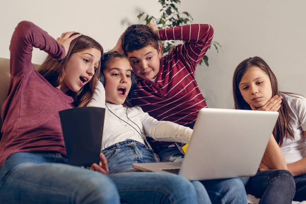 Laughing friends watching funny video on laptop - Photo, image