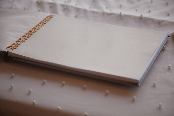 Blank Wedding Guest Book Page on the Reception Desk Background. Wedding Accessories, Wedding Reception, Organizing and Planning Events, Good Wishes, Messages and Congratulation concept - Φωτογραφία, εικόνα
