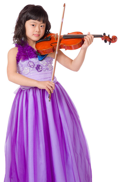 A portrait of a cute, happy and young Japanese girl in a purple dress on a white background with a violin. - Foto, Imagem