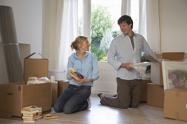 Couple unpacking boxes at home - Photo, Image