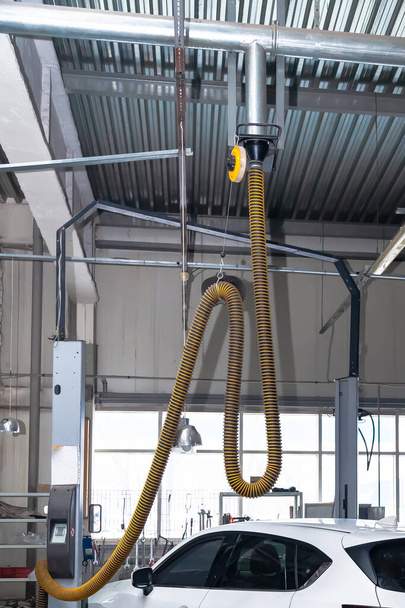 Removing exhaust gases with a yellow pipe to clean the environme - Photo, Image